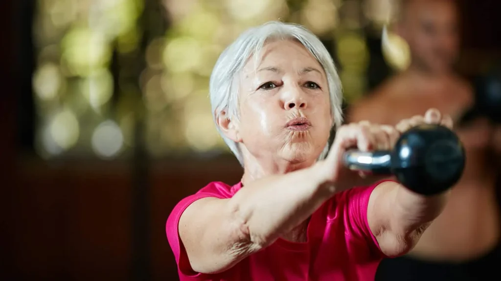 Toning Bingo Wings: Effective Exercises and Tips for Achieving Sleeker Arms 2 Person performing arm exercises with dumbbells Smethwick
