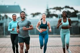 Sculpting Sleek Arms: The Essential Role of Cardio in Toning Without Bulking Up 3 image of people running to incorporate cardio Smethwick exercise into their life to help tone arms and body.